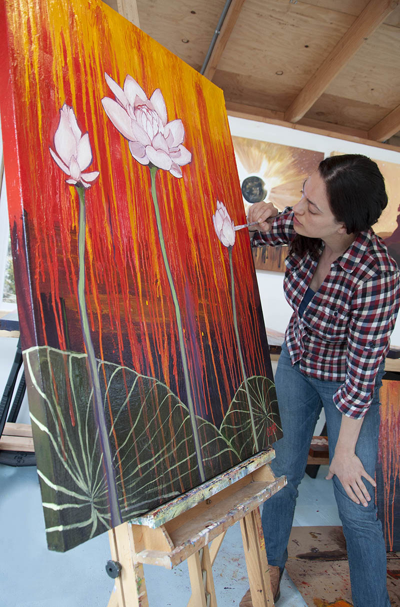 Cedar Lee painting in the studio: Lotus art: Courage Blooms
