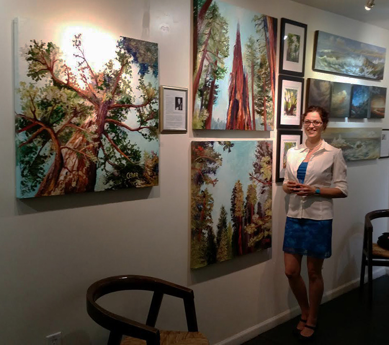 Artist Cedar Lee with her paintings at Art Tradition Gallery in Escondido, CA