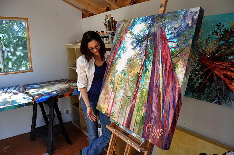 Cedar Lee in her art studio with painting Awakened Hope