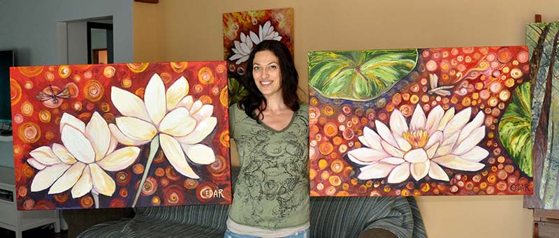 Artist Cedar Lee with Lotus paintings: Dragonfly's Discovery (left) and Resting Place (right)
