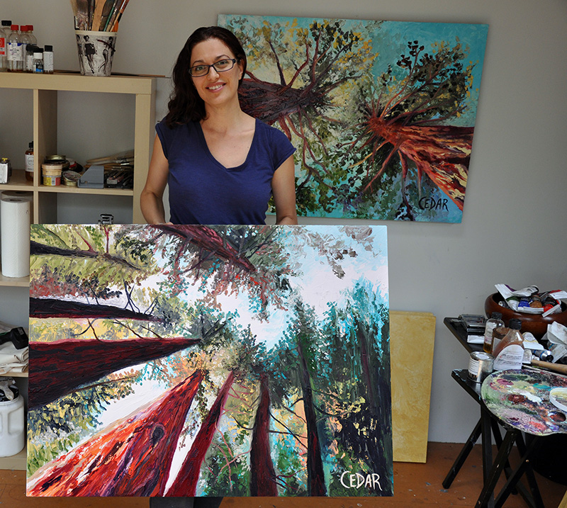 Cedar Lee with painting: Oxygen. 30" x 40", Oil on Wood, © 2014 Cedar Lee (Background: Quest For Light. 30" x 40", Oil on Wood, © 2014 Cedar Lee)