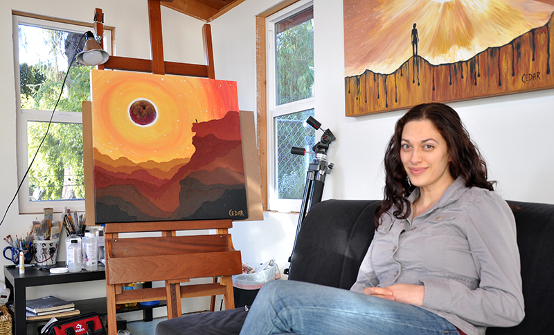 Cedar Lee in studio with Eclipse paintings. Left: "Eclipse Day Climber" Right: "A Dream of Joy and Sorrow"