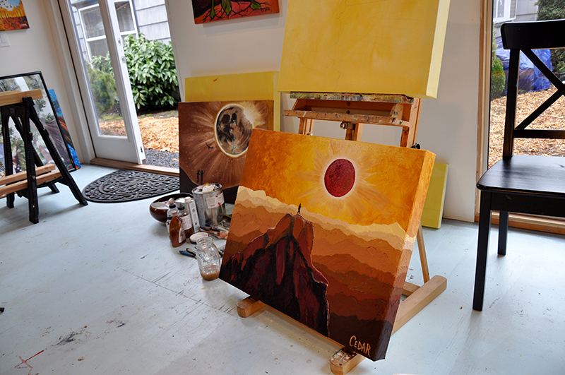 Cedar Lee Eclipse paintings in studio. On easel: "Eclipse at the Top of the World"