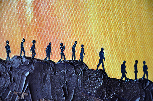 Close-up detail: Small silhouettes of people on the cliff