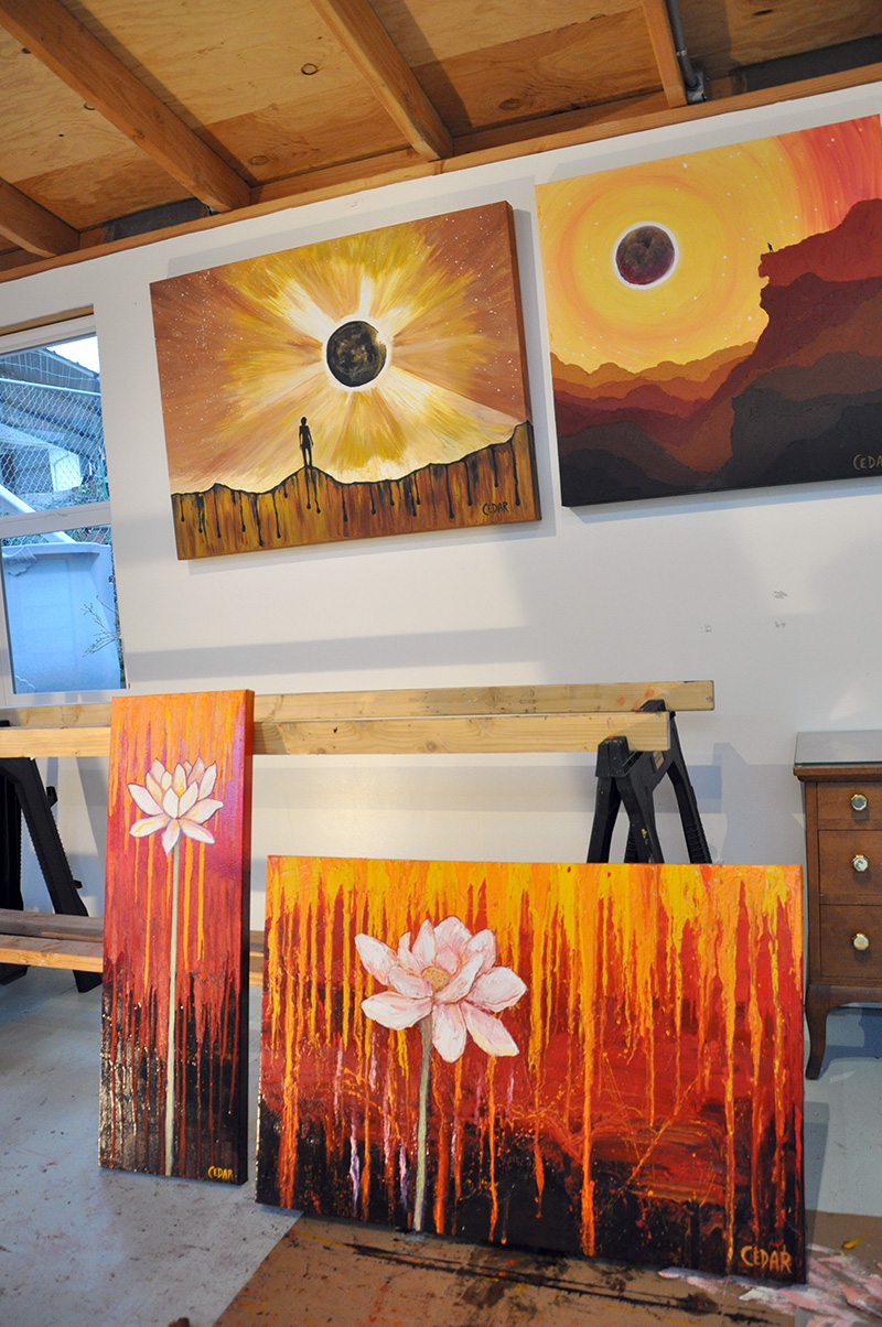 Eclipse and Lotus artwork in Cedar Lee studio: left-right, top-bottom: "A Dream of Joy and Sorrow," "Eclipse Day Climber," "Stand Tall," "Against All Odds"