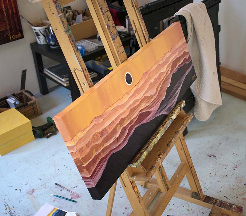 Painting on easel in art studio of Cedar Lee. Appalachian Eclipse. 12″ x 36″, Oil on Canvas, © 2017 Cedar Lee 