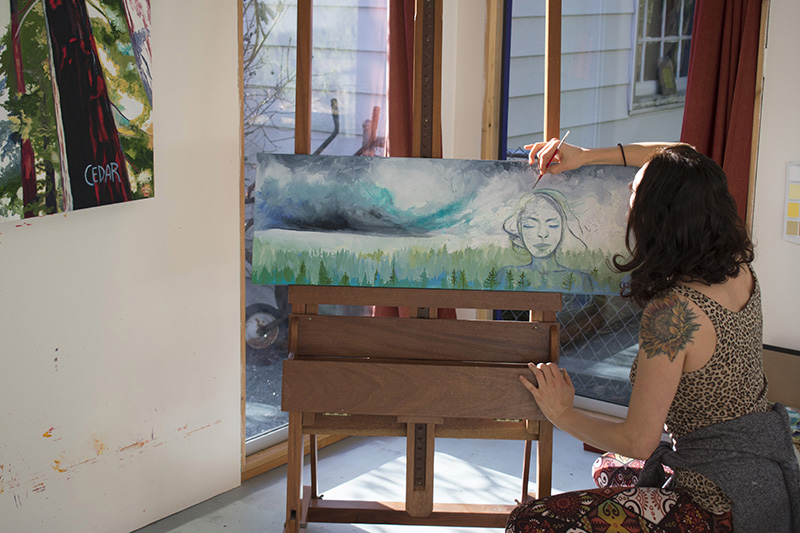 Artist Cedar Lee working in painting studio: Visions of Rain. 12" x 36", Oil on Canvas, © 2017 Cedar Lee