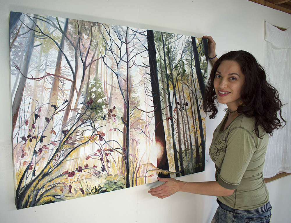 Artist Cedar Lee in the studio with painting: Wild Wood. 30" x 40", Oil on Wood, © 2018 Cedar Lee