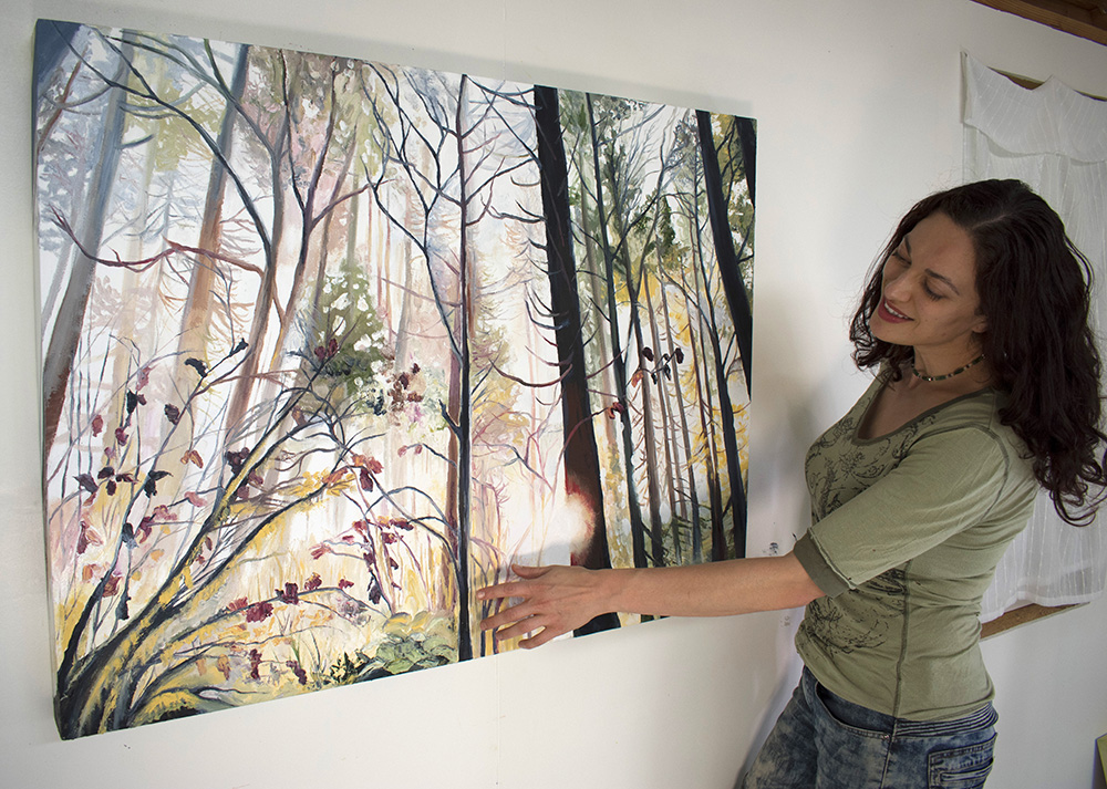 Artist Cedar Lee in the studio with painting: Wild Wood. 30" x 40", Oil on Wood, © 2018 Cedar Lee