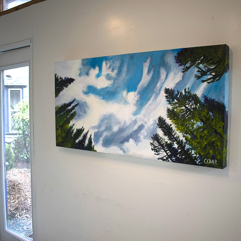 Painting by Cedar Lee of clouds floating in a blue sky over evergreen trees.