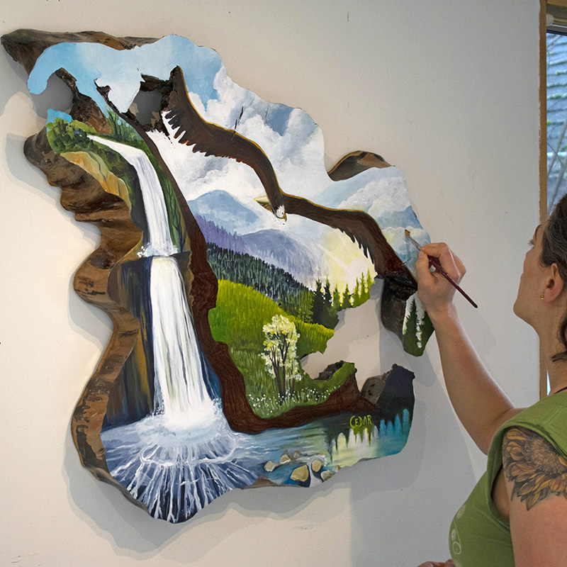 Art process of Cedar Lee painting on a live edge slab
