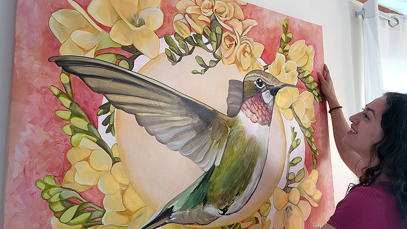 Cedar Lee with painting of hummingbird