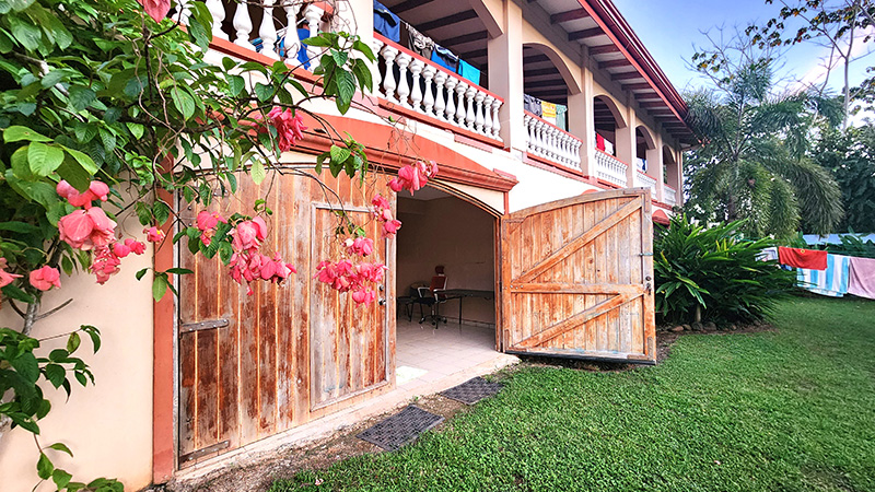 Open barn door leading to the shared artist studio space at the Mauser Ecohouse villa in Costa Rica