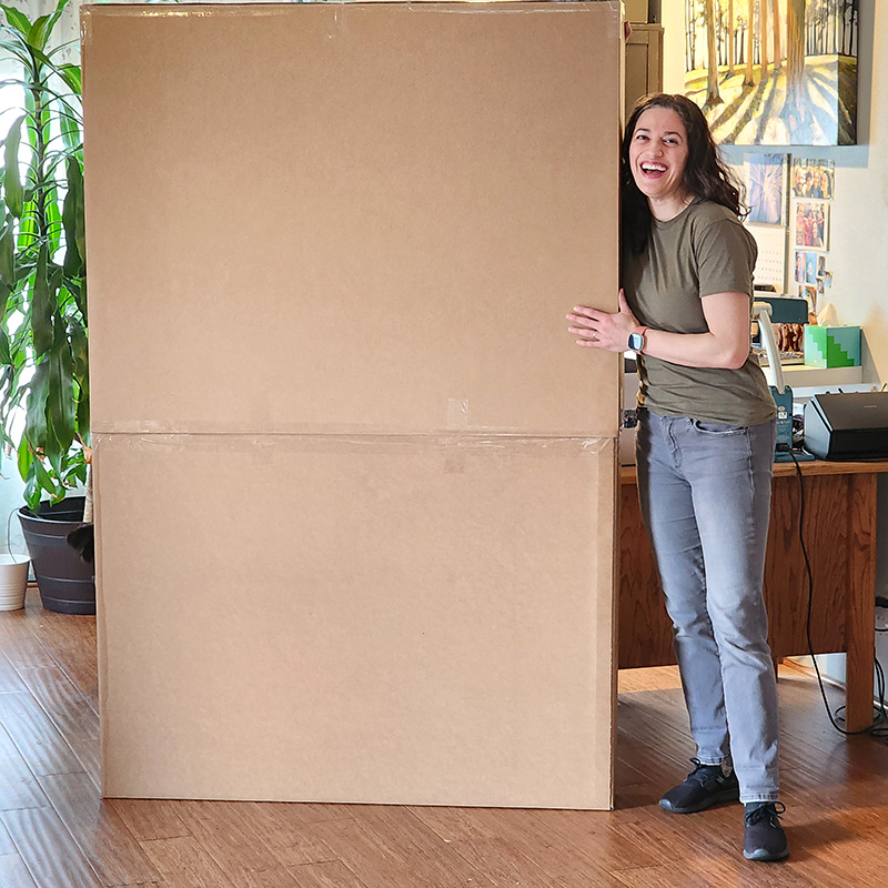 Cedar Lee packing large painting for shipment