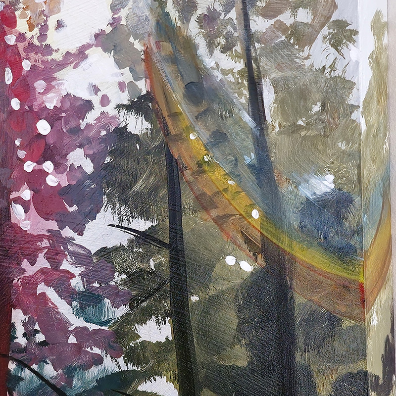 Closeup detail of rainbow light over trees